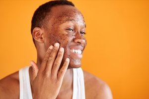 Woman rubbing an exfoliating cleanser on her face